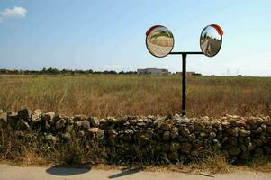 a rock fence with two mirrors on it photo