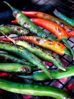 local Thai northern style cooking chili sauce and grilled chili in stone mortar photo