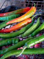 local Thai northern style cooking chili sauce and grilled chili in stone mortar photo