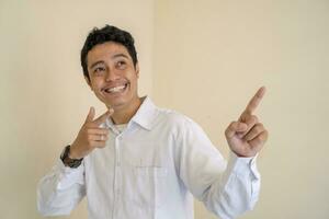 Young Indonesian curly man wear white clothes with thumbnail pose. photo