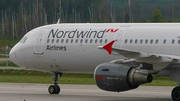 MOSCOW, RUSSIAN FEDERATION JULY 29, 2021 - Airbus A321 of Nordwind Airlines taxiing at Sheremetyevo airport. Passenger airplane on the airfield, side view. Travel concept video
