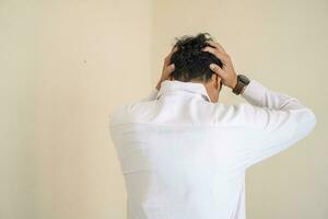 Indonesian office employee wear white clothes feel stress and unhappy expression. photo