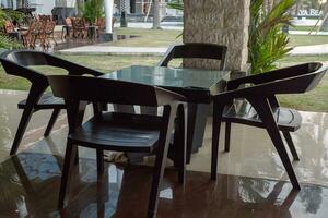 Empty chair and table with beautiful background and cloudy sky on the restaurant. The photo is suitable to use travel destination, holiday and vacation content media.