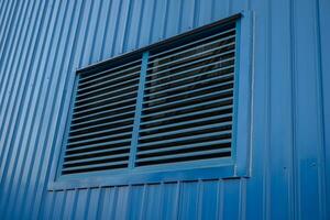 Blue windows air ventilation on power plant building. The photo is suitable to use for architect content media and building background.