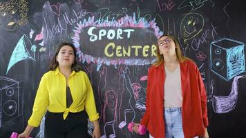 Young woman writing Sports Center on blackboard. video