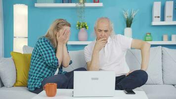 Married couple watching horror movie on laptop at home. video