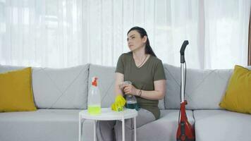 Pensive woman cleans the house. video