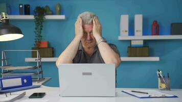 Home office worker man looks at camera with happy and smiling face. video