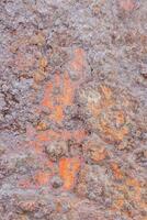a close up of a rock with orange paint photo
