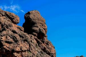 a rock formation with a blue sky in the background photo