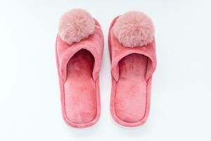 Pink home fluffy slippers on white background photo