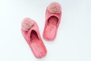 Cute home pink fluffy slippers on white background photo