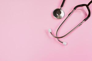 Stethoscope on pink background. Health care concept. Medical instrument for diagnosing diseases. photo