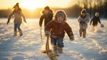 Group of happy children having fun, play tug of war on snow in winter park at sunset. photo