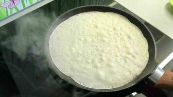 baking pancakes in a hot frying pan, close-up video