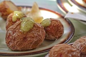 tasty Canarian potatoes cooked with a skin in seawater and served with a regional green sauce photo