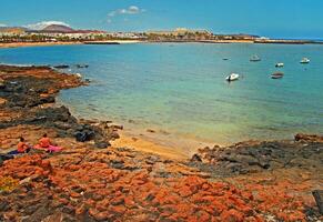 seaside landscape with ocean beach and blue sky on the island of Lanzarote in spain photo