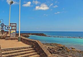 seaside landscape with ocean beach and blue sky on the island of Lanzarote in spain photo