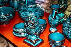 handmade clay dishes in the Greek style in the shop at the potter's workshop photo