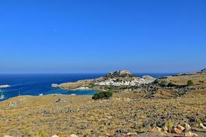 summer landscape of the Greek island of Rhodes with blue cloudless sky and sea photo