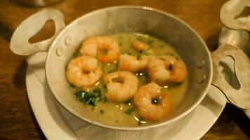 Zoom in close up on gourmet delicious shrimps in butter in restaurant video