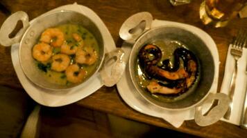 Two plates with gourmet and delicious seafood made of fried octopus and shrimps video