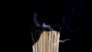 Matches burned out and abstract fumes are released in background. Slow motion footage video