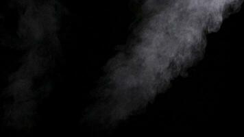 Abstract steam and fumes rising in the air in slow motion on black background video