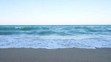 Large view slow motion of waves in the sea breaking on the beach video