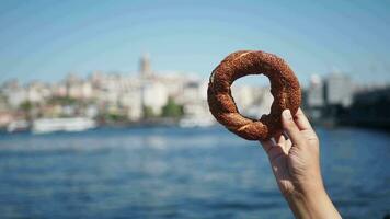 women holding a Turkish Bagel Simit against istanbul city background video