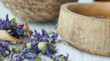 Essential lavender oil and flowers on table with copy space video