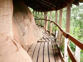 wooden bridge in the woods, Wooden walkway on sandstone mountains at Phu thok temple, Thailand, Beautiful scenery of wooden pathway along the cliff photo