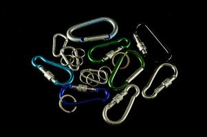 a variety of carabines and hooks on a black background photo