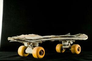 a skateboard with wheels made from wood and yellow wheels photo