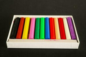 a box of colored crayons in a white box photo