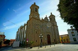 a church with two towers on a cobblestone street photo