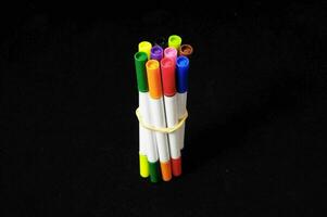 a group of colored markers in a holder photo