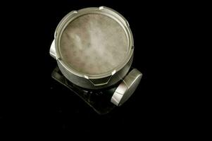 a silver object sitting on top of a black surface photo