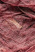 a pile of orange fishing nets photo