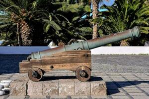 a cannon is sitting on the wall overlooking the ocean photo