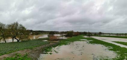 agrícola campos y carreteras inundado debido a pesado lluvia en Portugal foto