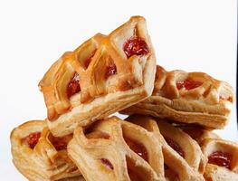 Puff pastry pastry with lingonberry jam on a white background. Cookies with lingonberry jam. photo