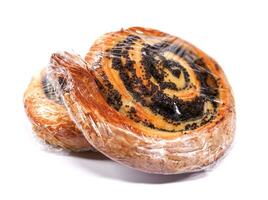Two buns with poppy seeds wrapped in film isolated on a white background. photo