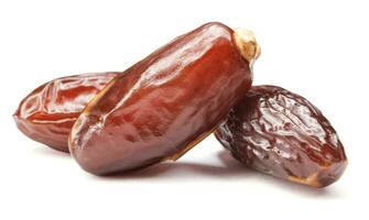 Three ripe dates isolated on a white background. Full clipping path. Dates . photo