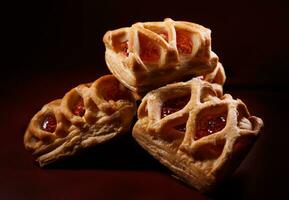 Puff pastry pastry with lingonberry jam on a dark red background. Cookies with lingonberry jam. photo