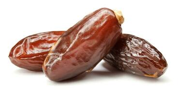 Three ripe dates isolated on a white background. Full clipping path. Dates . photo