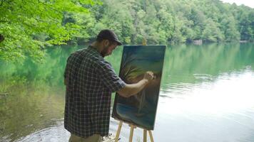 pintor pintura de a lago. video