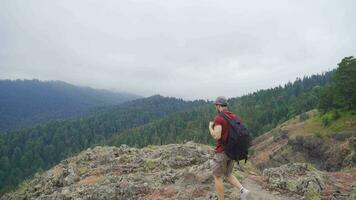 Man walking on top of mountains. video