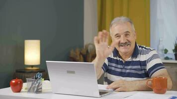 Home office worker man talking facetime looking at camera. video