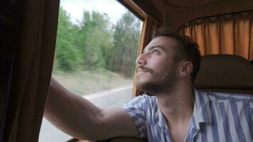 Young man looking out from inside the vehicle. video